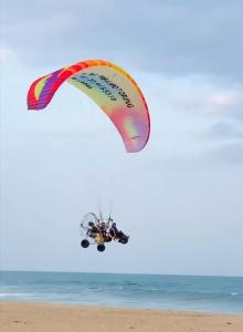 a kite flying in the air over the beach at Beach Wave Hotel in Arugam Bay