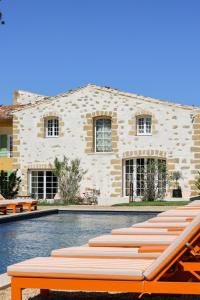 a building with a swimming pool in front of it at Domaine Robert in Rognes