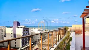 a view of the ocean from a balcony at Buenos Ayres Cabo Branco Genius Flats in João Pessoa