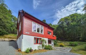 a red and white house with a red roof at Lovely Home In Masfjordnes With Wifi in Masfjorden