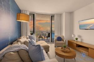 a living room with a couch and a table at Balcony with Infinite Views - Poolside Comfort in Hallandale Beach