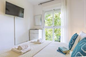 a bedroom with a bed with towels and a window at El Velero in El Tosalet +27 photos