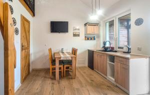 a kitchen with a table and a small table and chairs at 1 Bedroom Gorgeous Home In Sarbinowo in Sarbinowo