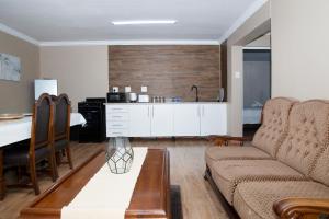 a living room with a couch and a kitchen at 20 On Percy Unit 3 in Parkwood