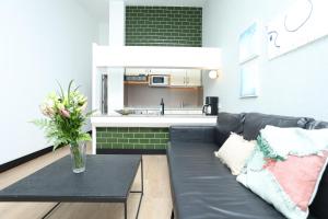 a living room with a couch and a kitchen at Sahara Beach Club in Maspalomas +2 photos