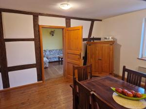 a dining room with a table with a bowl of fruit at Schlossgut Franken - Försterhaus in Redwitz an der Rodach