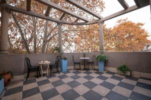 Un patio con sillas y mesas en un tejado. en Art house apartments, en Buenos Aires