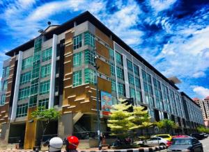 a building with people standing in front of it at Crystal Studio Apartment KBCP in Kota Bharu