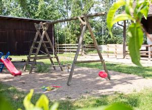 a playground with a swing set in a yard at Schlossgut Franken - Försterhaus in Redwitz an der Rodach