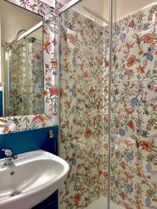 a bathroom with a sink and a shower at bruni rooms in Cirella