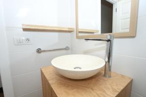 a bathroom with a white sink and a mirror at Sahara Beach Club in Maspalomas