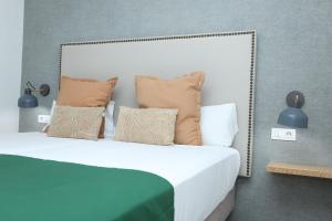 a bedroom with a bed with pillows on it at Sahara Beach Club in Maspalomas