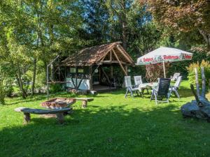 a gazebo with a table and chairs in a yard at Ferienwohnung in Gütenbach in Furtwangen