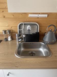 a kitchen sink with a tea kettle and a toaster at Lapland cabin in Kilpisjärvi +11 photos
