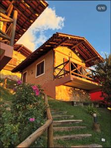 a house with a staircase leading up to it at Pousada Chales Rancho Caipira in Santo Antônio do Pinhal