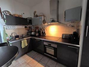 a small kitchen with a sink and a stove at Chambres à St Loup-Marseille in Marseille
