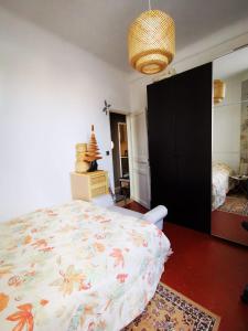 a bedroom with a large bed in a room at Chambres à St Loup-Marseille in Marseille