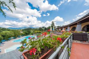 a view from the balcony of a resort with flowers at Camping Village Il Poggetto in Troghi