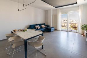 a living room with a table and chairs and a couch at MyHouse B&B - Trani dall'alto in Trani