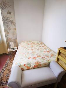 a bed sitting in a corner of a room at Chambres à St Loup-Marseille in Marseille +1 photo