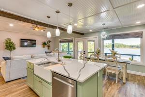 a kitchen and living room with a couch and a table at Bayfront Milton Retreat with Dock and Game Room in Milton