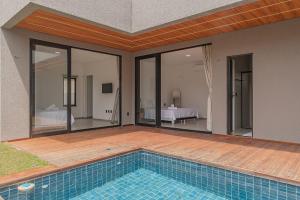 a swimming pool in the middle of a house at Summerville #269 - Casa em Cumbuco by Carpediem in Caucaia