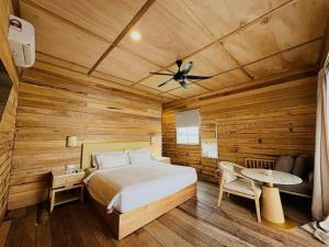 a bedroom with a bed and a ceiling fan at Sisipan Island Resort in Semporna