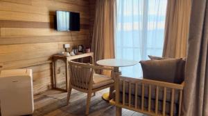 a room with a crib and a table and a chair at Sisipan Island Resort in Semporna