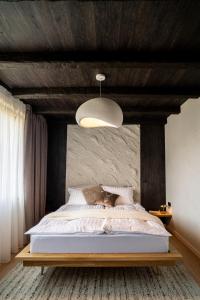 a bedroom with a large bed with a wooden ceiling at Avalanche Chalet in Poiana Brasov