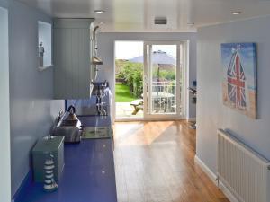 a kitchen with a blue counter and a door to a yard at Buckingham Cottage in Ventnor