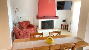 a living room with a table and a fireplace at Lovely house with amazing views in Chalkida