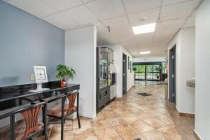 a hallway with blue walls and tile floors at Days Inn & Suites by Wyndham Mt Pleasant in Mount Pleasant