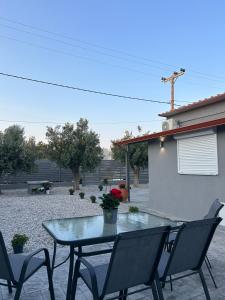 a table and chairs sitting on a patio at MtsHome in Áyios Spirídhon