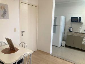 a kitchen with a table with a laptop on top of it at Apartamento em Gravataí in Gravataí