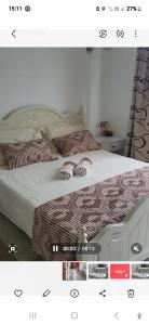a picture of a bed with two pillows on it at Spacious Apartment in Mahébourg with Sea View in Mahébourg