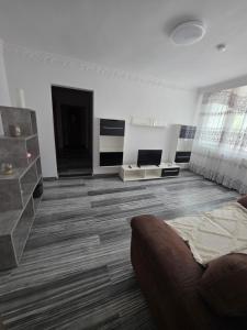 a white living room with a couch and a table at Bogdan my sun in Galaţi