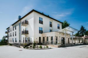 a large white building with a lot of windows at Hotel Radocza Park Business in Radocza