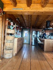a kitchen with wooden floors and a wooden ceiling at The Walpole Cabin in Mico