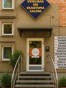 a building with a door with stairs in front at WooW kids club in Rīga +20 photos