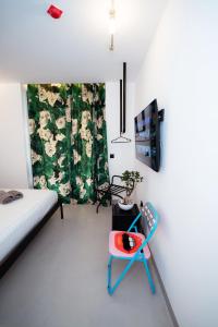 a bedroom with a bed and a blue chair at Splendida Vita in Tirane