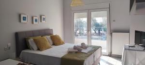 a bedroom with a bed with towels on it at Allure Loft in Nea Anchialos