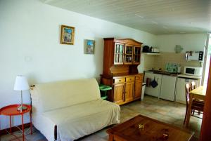a living room with a couch and a kitchen at La Vigneronne in Dijon