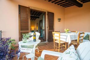 a patio with a table and chairs and a room with a door at Coliberto in Massa Marittima