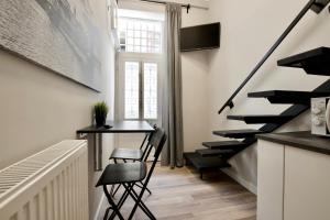 a hallway with stairs and a table and chairs at Standard Apartment by Hi5- Fehérhajó Studio in Budapest
