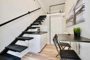 a staircase in a room with a table and chairs at Standard Apartment by Hi5- Fehérhajó Studio in Budapest