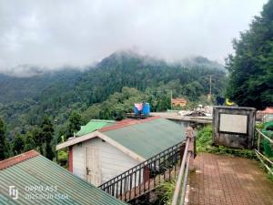 a view of a mountain with clouds in the sky at The Himalayan Horizon Homestay Lava in Lava