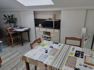 a kitchen with a table with a table cloth on it at Calme, proche Bordeaux - jardin et chats in Bassens +9 photos
