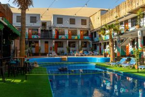a swimming pool in the middle of a building at Wild Rover Huacachina in Ica