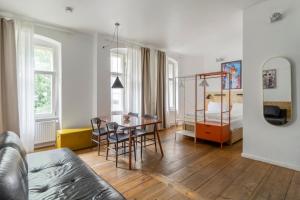 un soggiorno con un tavolo e una camera da letto di Mooeve Boxi Studios a Berlino
