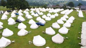 an overhead view of a large group of white tents at IntentsGP @ Spa-Francorchamps F1 in Francorchamps